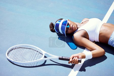 Photo for Sports fatigue and tired tennis girl on ground in sun with athlete burnout at tournament practice. Athletic black woman exhausted at professional tennis court for competition and fitness training - Royalty Free Image