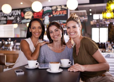 Photo for The three musketeers. Three friends sitting together in a restaurant having coffee - Royalty Free Image