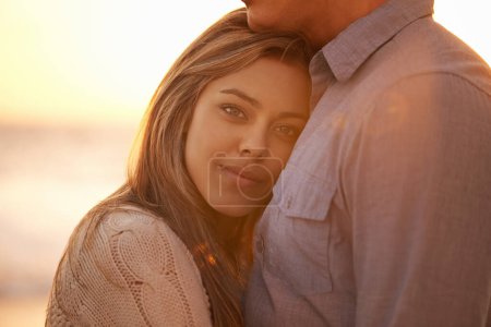 The heart that loves is always young. Portrait of a happy young couple enjoying a romantic embrace on the beach at sunset