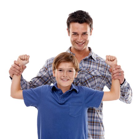 Photo for Hes becoming a strong young man. Studio shot of a father holding up his sons strong arms - Royalty Free Image