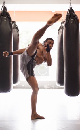 Photo for Your head is coming off. a young kick boxer working out in a gym - Royalty Free Image