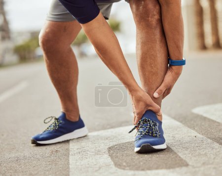 Téléchargez les photos : Fitness, pain in ankle and hands of black man with muscle ache, joint pain and injury after running in city. Sports, body wellness and male athlete rest after workout, marathon training and exercise. - en image libre de droit
