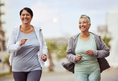 Fitness, city or senior friends running in a marathon challenge with sports performance goals on urban city street. Happy, runners or healthy mature women in cardio workout, training or body exercise.