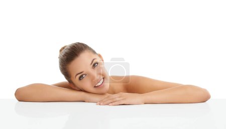 Foto de My flawless skin makes me happy. Studio portrait of a gorgeous young woman smiling against a white background - Imagen libre de derechos