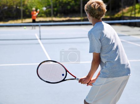 Photo for Ready for the serve. Rearview shot of a young man playing tennis - Royalty Free Image
