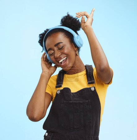 Music, dance and freedom with black woman and headphones, singing for relax, celebration and streaming. Audio, smile and technology with girl listening to online radio for playlist, energy and happy.