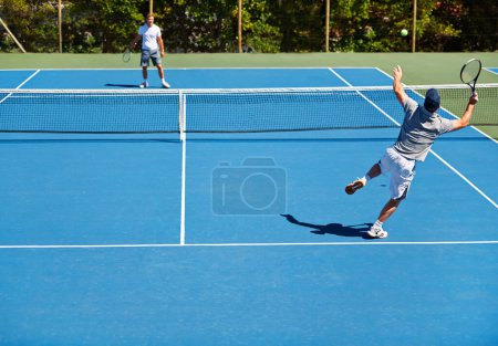 Photo for Showing up to every tennis practice. two people playing tennis outside - Royalty Free Image