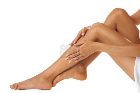 Foto de Hand, legs and woman on studio floor for wellness, luxury and hygiene treatment with mockup. Hands, model and leg of girl feeling feminine, soft and glow after self care routine on white background. - Imagen libre de derechos