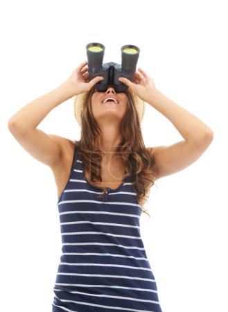 Photo for Whats that over there. A gorgeous young woman looking at something interesting with her binoculars - isolated - Royalty Free Image