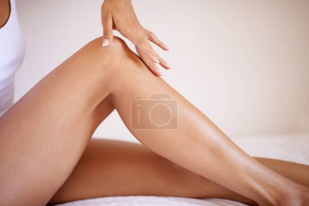 Photo for Woman, laser hair removal and touch legs for skincare, wellness and beauty. Female hands, leg and healthy skin care for body cosmetics, shine and epilation of soft aesthetic, natural glow and results. - Royalty Free Image