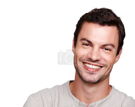 Téléchargez les photos : Smile portrait, handsome man and close up in white background for happiness, positive mindset and relax lifestyle. Model face, happy and big smile, calm energy and confidence isolated in studio. - en image libre de droit