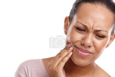 Woman, hand and mouth in pain from wisdom teeth, surgery or dental emergency against a white studio background. Isolated female suffering from painful oral, gum or tooth injury on white background.