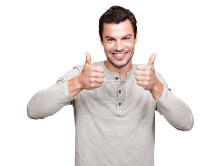 Téléchargez les photos : Portrait, thumbs up and emoji with a man in studio isolated on a white background as a winner or for motivation. Thank you, goal and target with an excited man giving a positive hand sign of support. - en image libre de droit