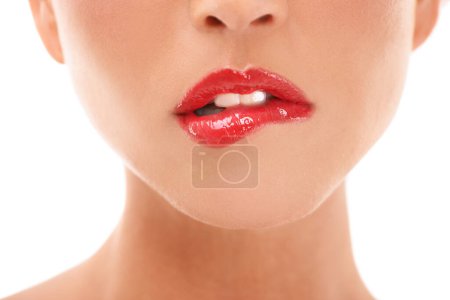 Téléchargez les photos : Beauty, makeup and red lips closeup of woman in studio for lipstick, grooming and hygiene on white background. Zoom, mouth and girl with lip gloss product flirt, seductive and bite, isolated and sexy. - en image libre de droit