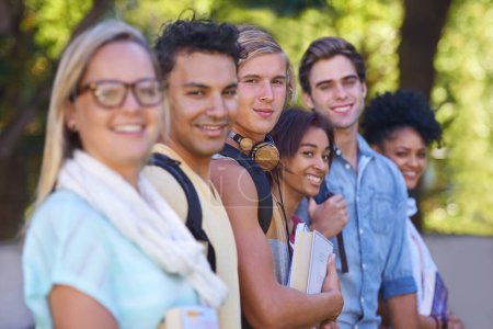 Photo for Smile for the camera. Portrait of a group of smiling university students standing outside - Royalty Free Image