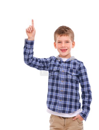 Foto de Kid, portrait and hand pointing to idea space with optimistic, friendly and happy smile for advertising. Happiness, cute and young child presenting mock up for marketing on isolated white background - Imagen libre de derechos