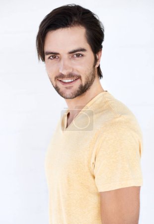 Téléchargez les photos : Fashion, happy and portrait of a man in a studio with casual, stylish and trendy clothes. Friendly, smile and young male model from Spain with a modern style outfit isolated by a white background - en image libre de droit