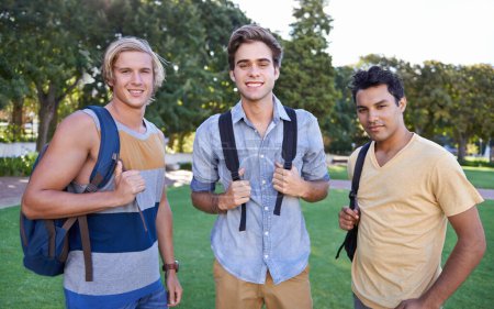 Photo for Ready to learn. Portrait of three students standing together in a park - Royalty Free Image