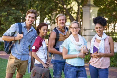 Photo for Getting through college together. Portrait of a group of smiling university students standing outside - Royalty Free Image
