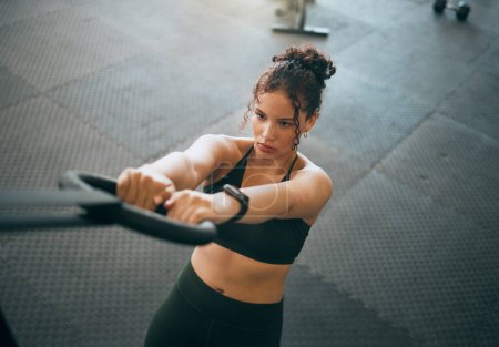 Foto de Exercise, gymnast ring and woman doing fitness workout , strength training and body wellness routine. Strong sports female or athlete with dip rings for power, self care and a healthy lifestyle. - Imagen libre de derechos