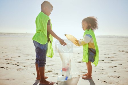 Foto de Children, plastic bottles or beach clean up in climate change, environment sustainability or planet earth recycling. Boy, girl or students in cleaning sea, ocean waste management or community service. - Imagen libre de derechos