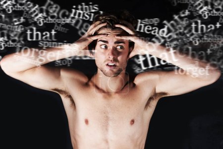 Photo for Hes hearing voices. A young man holding his head surrounded by words - Royalty Free Image