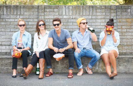 Photo for The party never ends...Young hipster friends drinking together while sitting outdoors - Royalty Free Image
