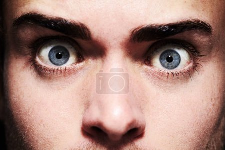 Photo for His eyes give away his fear. Closeup portrait of a young man with wide eyes - Royalty Free Image