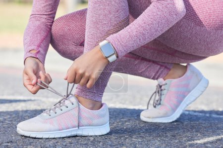 Foto de Woman, shoes lace and fitness run outdoor for cardio training workout, sports exercise and runner sneakers wellness in street. Running marathon, ready and feet zoom or sportswear shoe check in city. - Imagen libre de derechos