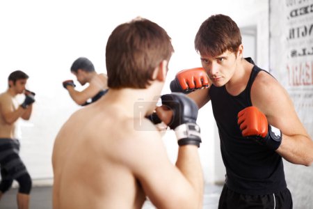 Foto de Bring it on. two martial artists sparring in the ring - Imagen libre de derechos