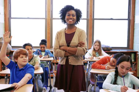 Photo for Portrait, student question and black woman teacher in classroom or middle school. Education, arms crossed or boy raising hand to answer questions, studying or learning help with happy female educator. - Royalty Free Image