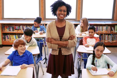 Photo for Portrait, black woman and teacher with students learning in classroom or middle school. Arms crossed, education scholarship and confident and happy female educator with children ready for studying - Royalty Free Image