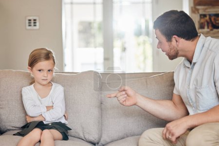 Photo for Theres no winning arguments with your parents. a young father reprimanding a child at home - Royalty Free Image