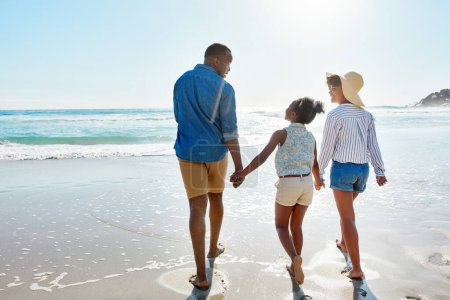 Photo for Summer, ocean and black family on a walking on a tropical, beach and relaxing at the sea and enjoying the scenery. People, water and parents with daughter, child or kid with childhood freedom. - Royalty Free Image