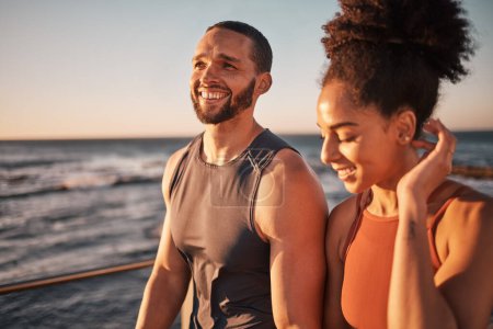 Photo for Black couple, fitness and walking at the beach in conversation or talk together with smile for the outdoors. Happy man and woman enjoying fun sunset walk smiling for holiday break by the ocean coast. - Royalty Free Image