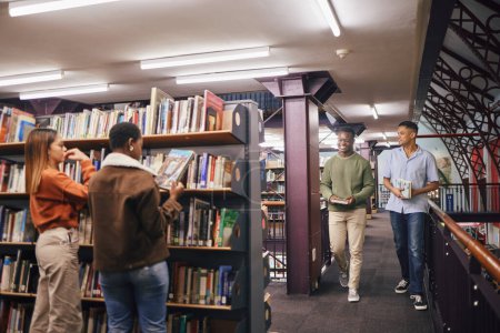 Foto de Students, reading or library books for college education, university learning or school studying. Smile, happy men or women in bookstore for textbook research, scholarship degree goals or group study. - Imagen libre de derechos