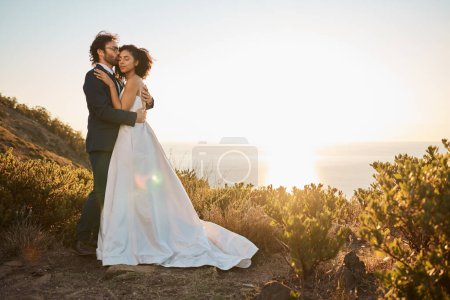 Téléchargez les photos : Mountain, wedding or a couple of friends hug in a romantic celebration in an interracial marriage. Sunset, black woman and happy man enjoy a lovely memory or commitment as bride and groom together. - en image libre de droit