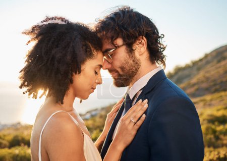 Téléchargez les photos : Marriage hug, interracial couple and nature with people outdoor for wedding and save the date. Close, love celebration and bride with man for commitment, care together feeling calm. - en image libre de droit