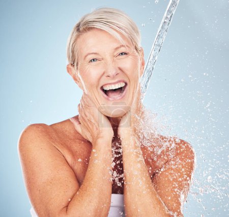 Photo for Portrait, old woman and water splash for cleaning, skincare or lady smile on grey studio background. Healthy, senior female or liquid for washing, dermatology or wet for hygiene, clear or smooth skin. - Royalty Free Image