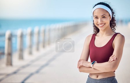 Photo for Happy woman, portrait and fitness with arms crossed at beach promenade for exercise, wellness and mockup in Miami. Female athlete, smile and standing at seaside for workout, summer training or sports. - Royalty Free Image