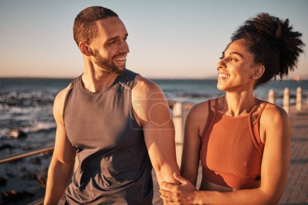 Photo for Black couple, fitness and walking at the beach with smile for conversation, talk or sunset together in the outdoors. Happy man and woman enjoying fun walk smiling for holiday break by the ocean coast. - Royalty Free Image