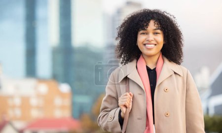 Foto de Business woman, portrait and smily of a young professional happy with a smile by urban building. Worker, smiling and happiness of a female by buildings excited about work success with mock up space. - Imagen libre de derechos