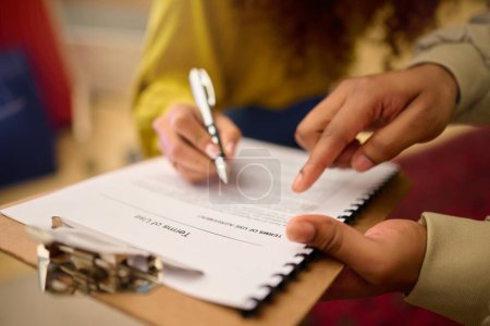 Foto de Contract, client hands and legal document of terms of use agreement with lawyer consultant. Signature, paperwork and assets policy of woman reading to sign documents with pen at a consulting meeting. - Imagen libre de derechos