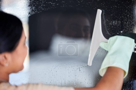 Photo for Woman cleaning window, cleaner and chemical for hygiene, surface disinfection and protection from bacteria. Housework, clean service and housekeeper with hospitality, janitor and water drops on glass. - Royalty Free Image