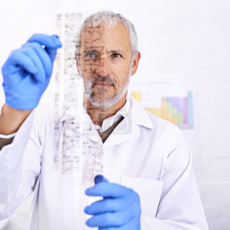 Photo for Studying your DNA. a male scientist examining the results of a DNA test - Royalty Free Image