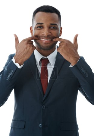 Photo for Putting on a positive face. A young businessman stretching his mouth into a smile while isolated on white - Royalty Free Image