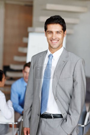 Photo for Leader among his colleagues. A young executive smiling at you confidently - Royalty Free Image