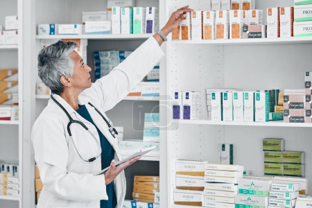 Photo for Pharmacy, tablet and medicine with senior woman in store for healthcare, wellness or retail. Product, technology and stock with pharmacist checking drugs outlet for shopping, medical or inventory. - Royalty Free Image