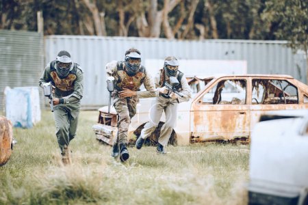 Téléchargez les photos : Paintball, mission or men running in a shooting game playing with speed or fast action on a fun battlefield. Focus, military or players with guns or weapons for survival in an outdoor competition. - en image libre de droit