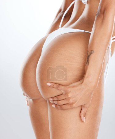 Photo for Model bikini, hands or lifting butt in bum surgery, cellulite goals or stretch marks solution for fat liposuction. Zoom, swimsuit or woman buttocks on isolated studio background in weight loss check. - Royalty Free Image